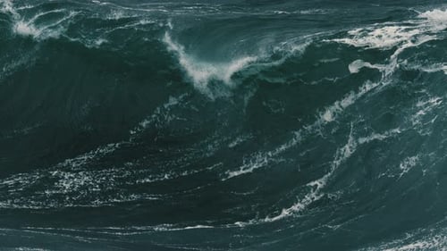 Large foamy wave barrelling onto a shallow reef. Slow motion.