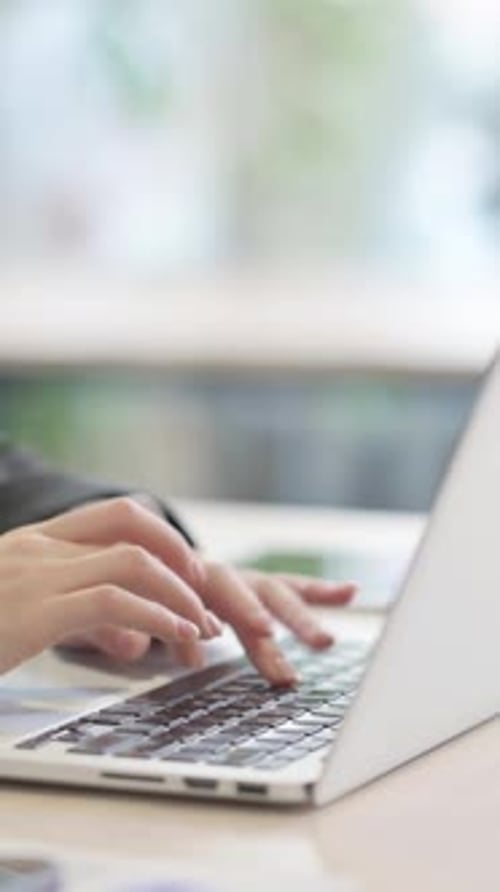 Close Up of Businesswoman Typing on Laptop, vertical
