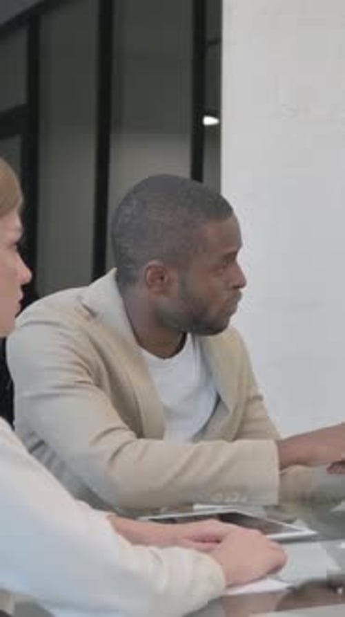Business People Having Discussion in Modern Office Setting