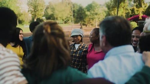 Happy multigenerational group of people with different ethnicities having fun in a public park