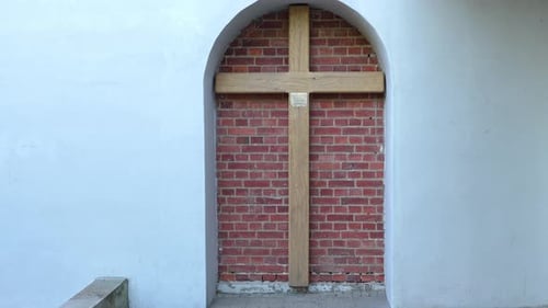 Cross on Brick Wall in Arched Recess – Zoom In