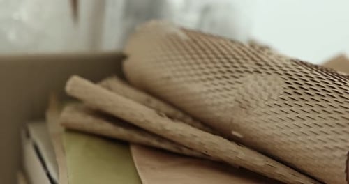 Different packaging materials on white background, closeup. Camera moving in and left