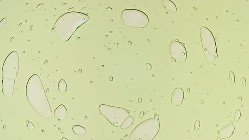 Transparent Green Cosmetic Gel Fluid With Molecule Bubbles and Oil on White Background Macro Shot