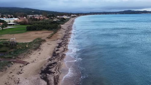 Long Sandy Coastline Aerial: Moody Sunrise or Sunset Drone View Over Tranquil Ocean Waves Breaking