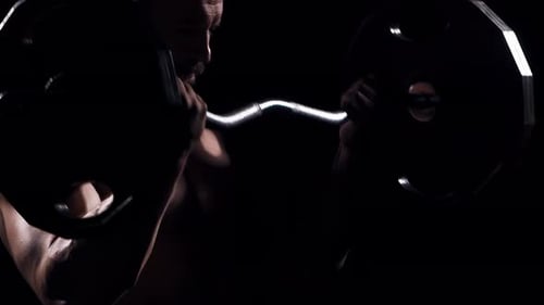 Fit and Sporty Bodybuilder Over Black Background Bodybuilder Training Using Barbell The Concept of