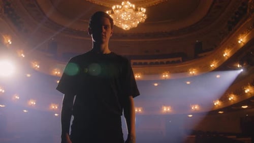 Ballet Male Dancer Stands on Stage and Looks at Camera