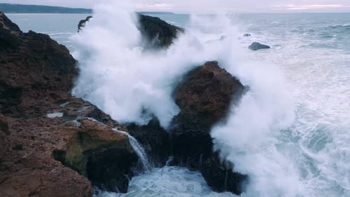 Dynamic Ocean Waves Crashing on Rugged Coastal Cliffs
