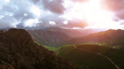 Majestic mountain landscape with vibrant sunset over green valleys