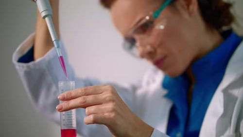 Scientist Examining Liquid Sample in Laboratory Test Tube