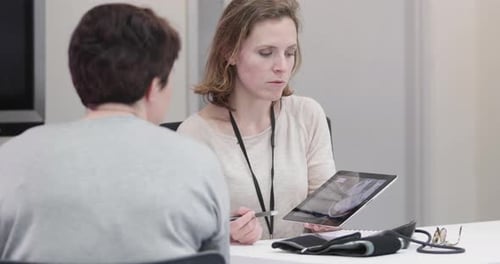 Doctor reviews medical imaging with a patient