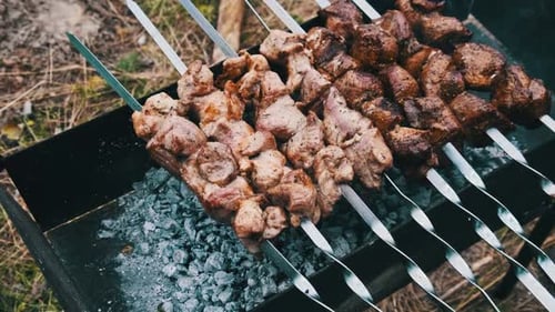 Meat Grilling on Skewers Outdoors