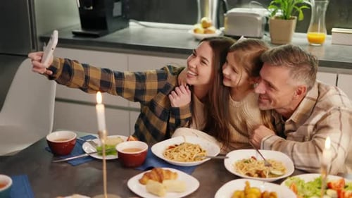 Loving Family Takes a Selfie at Dinner Table