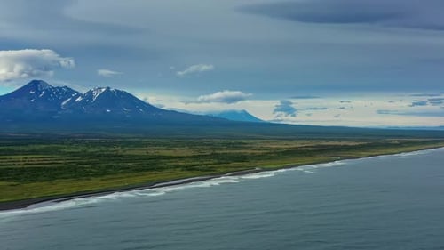 Beach with black sand and volcano