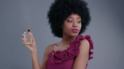 Woman Sprays Perfume in Fashion Studio