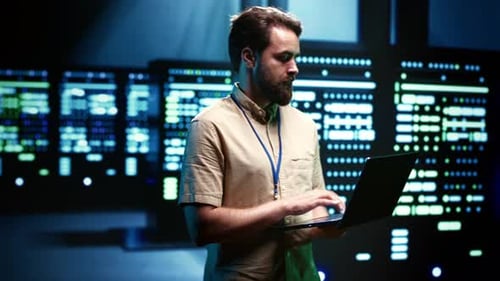 Young Adult Working on Laptop in Data Center