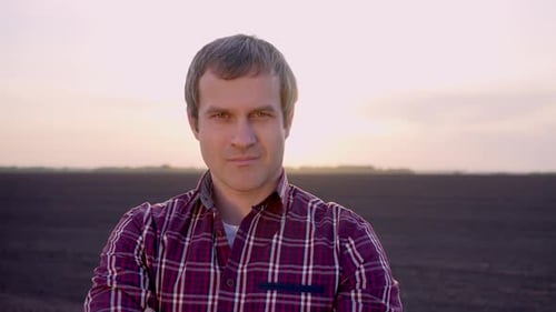 Farmer Man Portrait Looking at Camera at Field Sunset Harvesting Crop Farming