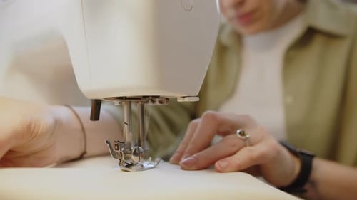 Woman Sewing Fabric with a Sewing Machine