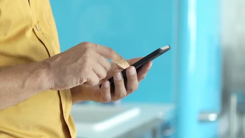 Man using mobile phone in a home setting