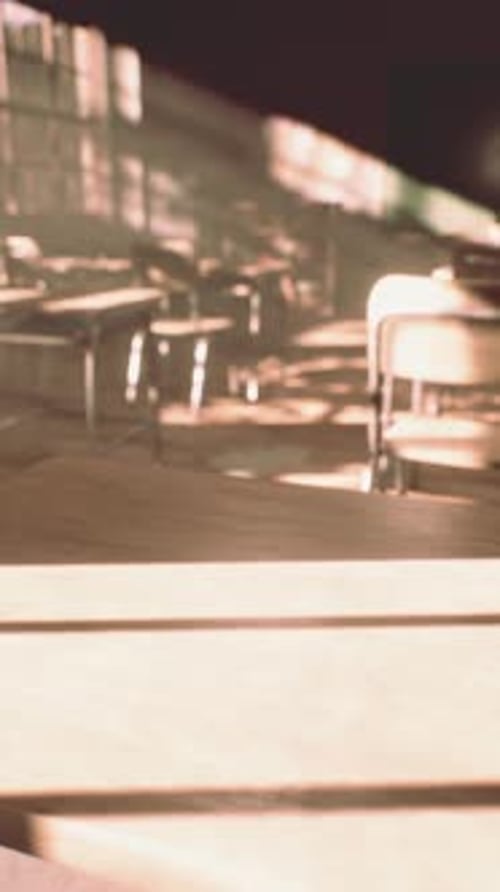 View to Classroom with Tables and Small Blackboard and Grungy Walls