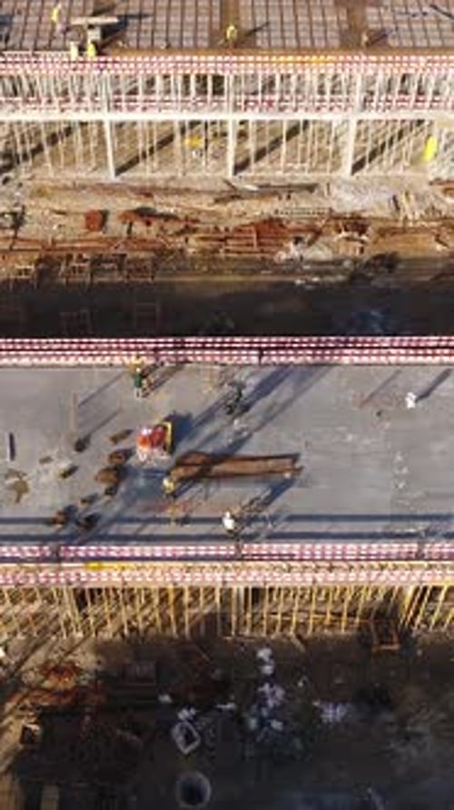 Vertical Video of Construction Workers in the Roof of New Building