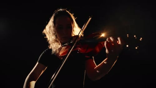 Violinist Performs in a Dark Setting