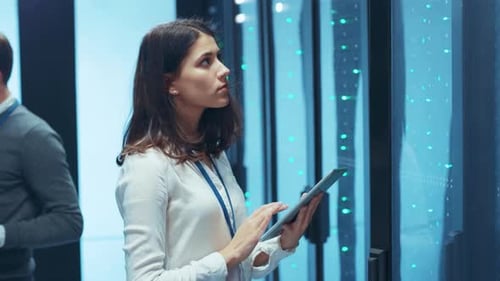 Technicians Using Technology in a Modern Server Room