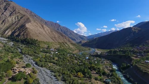 Aerial view of Himalayan mountains, river, village, Pakistan.