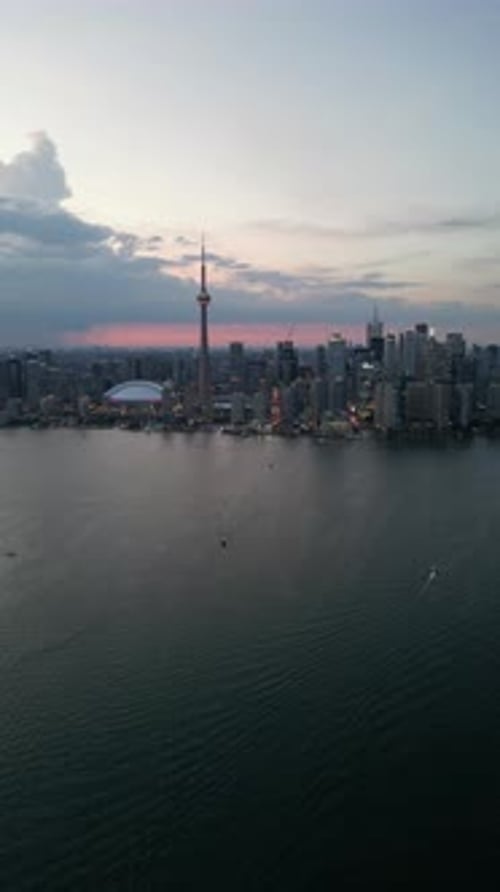 Aerial shot of downtown Toronto with the CN Tower towering into the sky, at night. in Canada