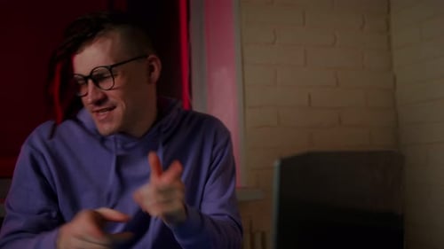 Young Man Dancing and Celebrating at Computer