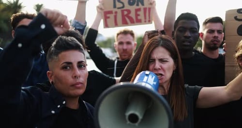 Diverse Group of People Protesting and Speaking Into Megaphone