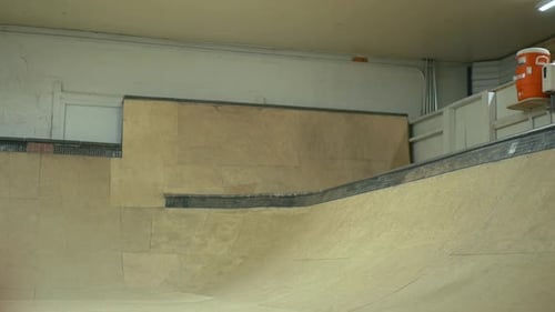 Young Adult Skateboarding in Indoor Skatepark