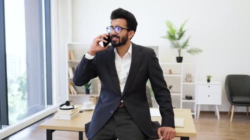 Man in Suit Talking on Phone in Office