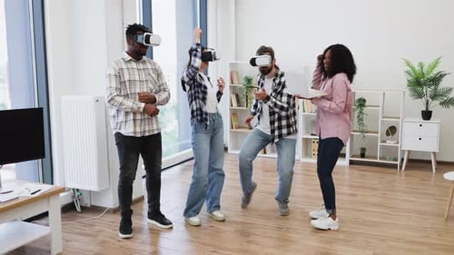 Diverse Professionals Using Virtual Reality Glasses in Modern Office Setting