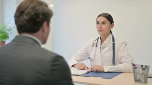 Doctor Consulting with Patient in Bright Office
