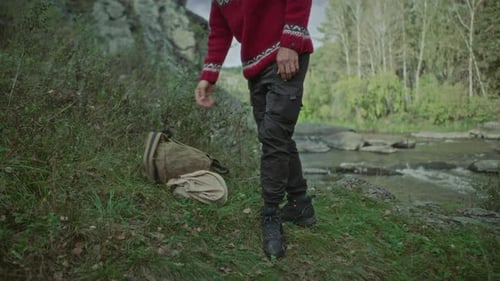 Man Sitting and Relaxing by Calm River