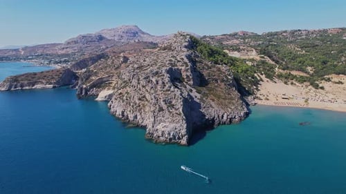 Scenic coastline and rocky cliffs with a boat in clear turquoise waters