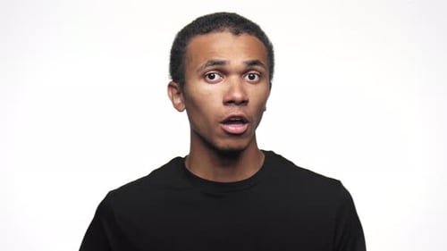 Young Man Reacts with Surprise and Sadness