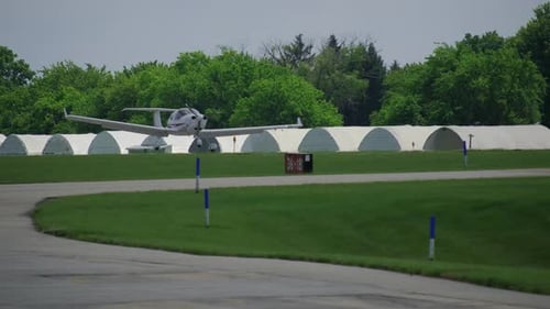 A Propeller Plane Preparing to Landing on the Runway at a Small Airport Slow Motion View