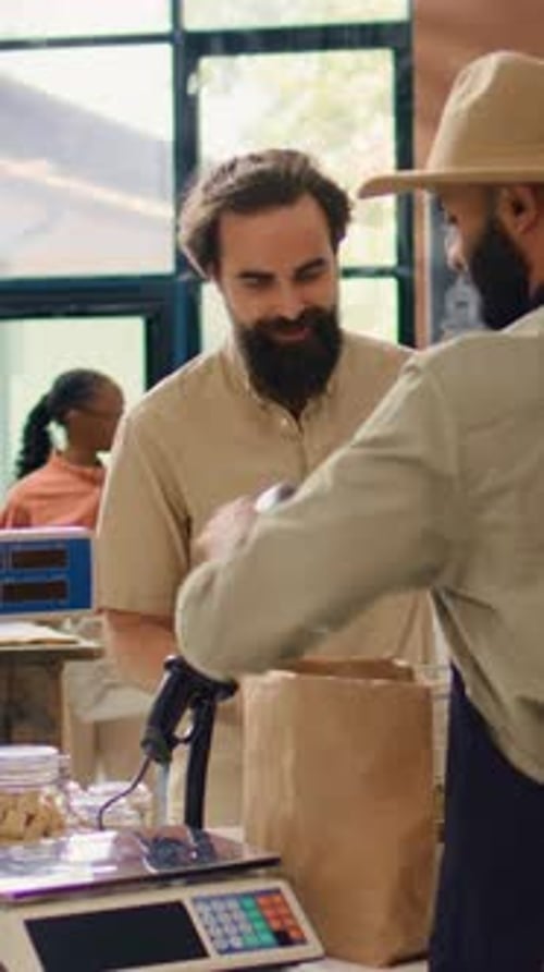 Vertical Video Storekeeper Serving Buyer with Produce