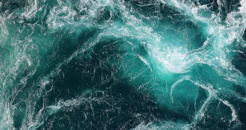 Blue waves of water of the river and the sea meet each other during high tide and low tide.