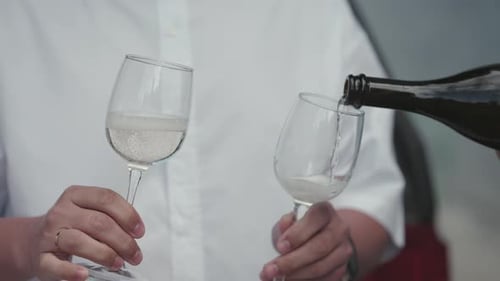 Pouring champagne into glass for celebration