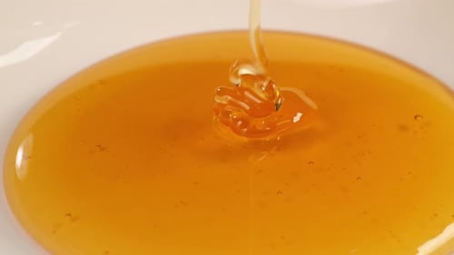 Honey Poured On A White Plain Background. Organic Thick Honey, Sweet Dessert