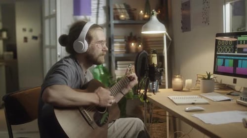 Musician Recording Guitar Song in Home Studio