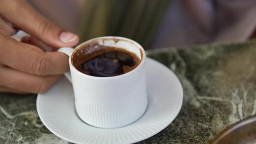 Enjoying a Rich Espresso in a Cozy Cafe