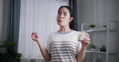 Woman Eating Healthy Snack Indoors, Bright Interior