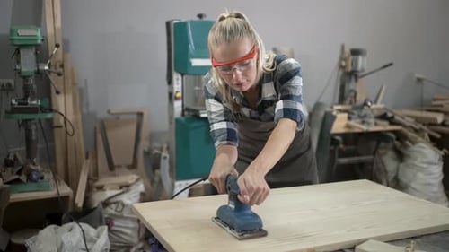 Carpenter is working at workshop.
