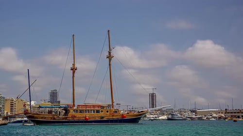 Old wooden vessel moored in docks of Valetta, time lapse view