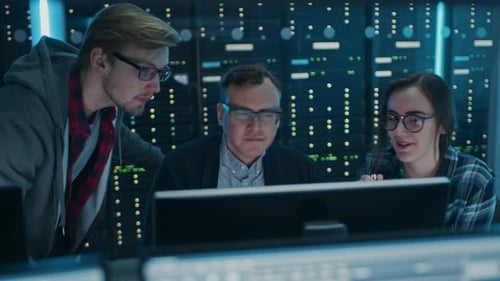 Male and Female IT Engineers / Programmers Having Discussion about Coding on Desktop Computers. Tec