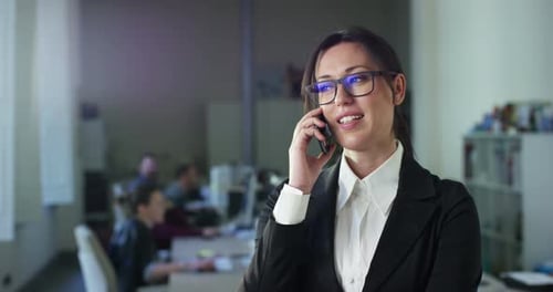 Portrait of Successful Businesswoman in Office, Making Important Phone Call and Closing a Deal wit
