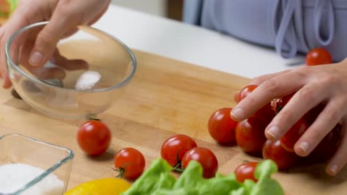 Woman Preparing Fresh Salad with Tomatoes and Lettuce